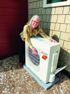 Martha Rose embracing a Heat Recovery Ventilator (HRV) as an energy-efficient heating source